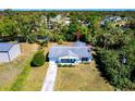 Aerial view of a charming single-story home with a well-manicured lawn and a gray roof at 410 Hinton St, Port Charlotte, FL 33954