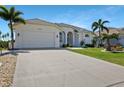 Attractive property showcasing lush lawn, two-car garage, and beautiful landscaping at 609 Macedonia Dr, Punta Gorda, FL 33950