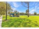 Community playground featuring play equipment and open green space for recreation at 1068 Harbour Cape Pl, Punta Gorda, FL 33983