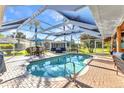 Screened-in pool area with an outdoor seating area, perfect for relaxing and entertaining at 1068 Harbour Cape Pl, Punta Gorda, FL 33983