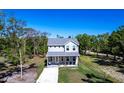 Two-story home showcasing its well-maintained exterior, complemented by lush greenery and a clear blue sky at 14289 Manatee Rd, Parrish, FL 34219