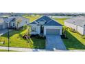 Charming single-Gathering home features a manicured lawn, beautiful landscaping and a two-car garage at 14381 Heritage Landing Blvd, Punta Gorda, FL 33955