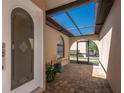 Welcoming covered entrance featuring brick pavers, a charming screen door, and ample natural light at 1780 Deborah Dr # 25, Punta Gorda, FL 33950