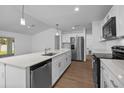 Modern kitchen with stainless steel appliances, white cabinets, and a large island at 18124 Goliad Ave, Port Charlotte, FL 33954