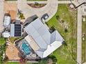 Expansive waterfront property featuring a pool, boat dock, and lush landscaping, providing a serene coastal living experience at 21194 Edgewater Dr, Port Charlotte, FL 33952