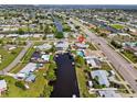 This aerial shot highlights the property's waterfront location with canal access and a private pool at 21194 Edgewater Dr, Port Charlotte, FL 33952