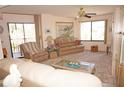 Bright living room featuring neutral carpeting and comfortable seating at 25188 Marion Ave # F106, Punta Gorda, FL 33950