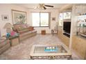Bright living room featuring neutral carpeting and comfortable seating at 25188 Marion Ave # F106, Punta Gorda, FL 33950