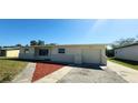 Attractive single-story home with a well-kept lawn, driveway, and an attached one-car garage at 3372 Elkcam Blvd, Port Charlotte, FL 33952
