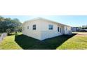 This single-story home has a well-maintained side yard and a white brick perimeter at 3372 Elkcam Blvd, Port Charlotte, FL 33952