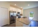 Modern kitchen with granite countertops, stainless steel appliances, and a pantry at 359 Paramaribo St, Punta Gorda, FL 33983