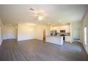 Spacious living room featuring a modern kitchen, ceiling fan, and hardwood floors at 359 Paramaribo St, Punta Gorda, FL 33983