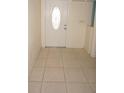 Entrance foyer featuring neutral tile flooring and an ornate front door at 594 W Tarpon Nw Blvd, Port Charlotte, FL 33952