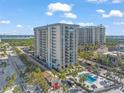 Stunning high-rise condo building with a pool and well-manicured landscaping at 1212 Benjamin Franklin Dr # 102, Sarasota, FL 34236