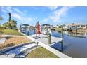 Waterfront dock perfect for boating, with boat lift and serene water views at 122 Colonial Se St, Port Charlotte, FL 33952