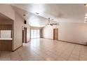 Bright and airy living room features tile flooring and sliding glass doors to the lanai at 16249 Ashland Ave, Port Charlotte, FL 33954