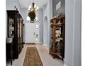 Elegant foyer with high ceilings, tile flooring, and stylish decor at 1701 Lastingham Ln, Port Charlotte, FL 33980