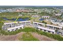 Community aerial showcasing multiple condo buildings, surrounding nature and a golf course at 175 Kings Hwy # 736, Punta Gorda, FL 33983