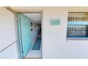 Entryway with a turquoise door and tile flooring, offering a glimpse into the interior at 175 Kings Hwy # 736, Punta Gorda, FL 33983