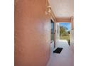 Side porch with view of blue sky, black door mat and outdoor sconce light at 179 Boundary Blvd # 4, Rotonda West, FL 33947