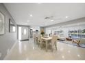 Bright, open-concept dining area with modern furnishings and natural light, adjacent to the living room at 1791 Belle Ct, Punta Gorda, FL 33950
