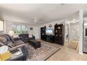 Comfortable living room featuring neutral walls, tile flooring, large windows with shutters, a ceiling fan, and elegant furnishings at 18417 Ohara Dr, Port Charlotte, FL 33948