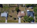 Aerial view of single-Gathering home featuring a lawn with mature trees and a private backyard at 23051 Elmira Blvd, Punta Gorda, FL 33980