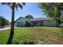 Charming single-story home featuring a two-car garage, arched entry and mature landscaping at 23051 Elmira Blvd, Punta Gorda, FL 33980