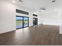 Bright living room showcasing large windows and sliding doors with backyard views at 24166 Colima Ct, Punta Gorda, FL 33955