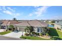 Well-kept home featuring a two-car garage, meticulous landscaping, and a serene pond view in a tranquil neighborhood at 24371 Westgate Blvd, Port Charlotte, FL 33980