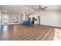 Spacious open concept living and kitchen space with lots of natural light from large windows, with sleek ceiling fan at 422 Ravenswood Blvd, Port Charlotte, FL 33954