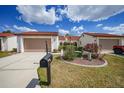 Charming townhomes featuring red tile roofs, inviting walkways, and attached garages at 5036 San Rocco Ct, Punta Gorda, FL 33950