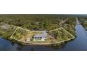 Aerial view of waterfront home with lush landscaping and access to canal at 535 Ramblewood St, Port Charlotte, FL 33953