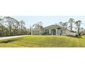 Attractive one-story home features a two car garage, well-kept lawn, and a picturesque setting at 5805 Casanova Ave, North Port, FL 34291