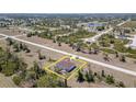 Aerial view of property showing house, pool, surrounding neighborhood, and large lot at 145 Brig E Cir, Placida, FL 33946