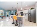 Bright, modern kitchen with stainless steel appliances, pendant lighting, and a breakfast bar with seating at 145 Brig E Cir, Placida, FL 33946