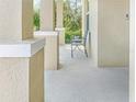 Open-air porch with stone pillars and space for seating, providing a welcoming entryway at 15172 Mcgraw Ave, Port Charlotte, FL 33953