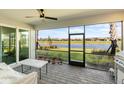 Screened lanai with comfortable seating, offering stunning waterfront views and a built-in grilling area at 15931 Sugar Hill Dr, Punta Gorda, FL 33982