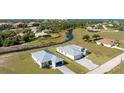 A captivating aerial shot of a home nestled in a thriving neighborhood, showcasing its beautiful landscaping and nearby creek at 17476 Vellum Cir, Punta Gorda, FL 33955