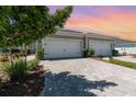 Beautiful home with a two-car garage and lovely stone driveway and landscaping at 17860 Palmetto Pass Ln, Punta Gorda, FL 33982
