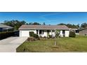 Charming single-story home with attached garage and well-maintained lawn, offering comfortable living at 18427 Goodman Cir, Port Charlotte, FL 33948