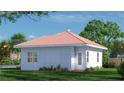 Rear view of white brick home with tidy landscaping and a traditional roof at 20208 Winkler Ave, Port Charlotte, FL 33954