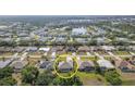 Aerial view shows the location of the property in a community with a swimming pool in a yard, close to a lake at 2132 Nuremberg Blvd, Punta Gorda, FL 33983