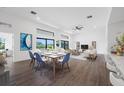 Open-concept dining area featuring modern decor, floor-to-ceiling windows, and a view of the outdoor living space at 24259 Peppercorn Rd, Punta Gorda, FL 33955