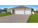 Charming single-story home featuring a spacious three-car garage and well-manicured lawn at 25336 Deep Creek Blvd, Punta Gorda, FL 33983