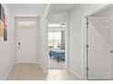 Inviting hallway with light wood floors, white walls and views of the bedroom at 25336 Deep Creek Blvd, Punta Gorda, FL 33983