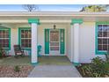 Welcoming front porch showcasing a stylish entrance with ample seating and decorative plants, enhancing curb appeal at 2631 Tomaso Rd, North Port, FL 34287