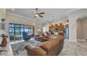 Open concept living area with waterfront views, a cozy leather sofa, and easy access to the kitchen at 2917 Mill Creek Rd, Port Charlotte, FL 33953