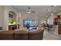 Spacious living room features tile flooring, a large leather sofa, and stunning waterfront views at 2917 Mill Creek Rd, Port Charlotte, FL 33953