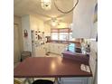 Cozy kitchen with white cabinets, stainless steel appliances, and breakfast bar at 715 Fairmount Dr, North Port, FL 34287